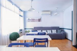 a room with a table and chairs and a couch at Barcelona City Street in Barcelona