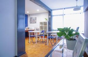 a room with two tables and chairs and a potted plant at Barcelona City Street in Barcelona