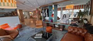 a living room with leather furniture in a store at Hôtel AKENA Biarritz - Grande plage in Biarritz