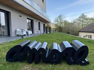 a row of benches in the grass in front of a building at Les Hutins in Gex