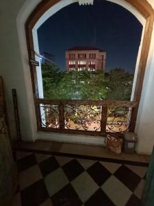 a window with a view of a building at Hostel Vasantashram CST Mumbai in Mumbai