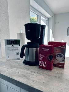 a coffee maker and a box on a counter at FeWo Euregio II - mit Terrasse in Nordhorn