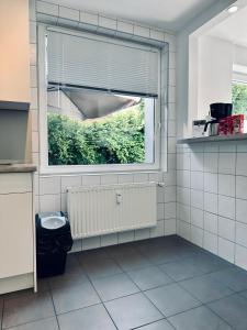 a bathroom with a large window and a radiator at FeWo Euregio II - mit Terrasse in Nordhorn