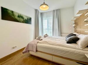 Posteľ alebo postele v izbe v ubytovaní Apartament Caroline Q4Apartments