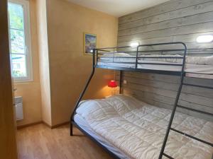 a bedroom with two bunk beds and a window at Appartement Cauterets, 3 pièces, 5 personnes - FR-1-401-248 in Cauterets