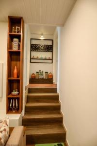 a stairway in a home with wooden floors and shelves at Apartment lake kurunegala in Kurunegala