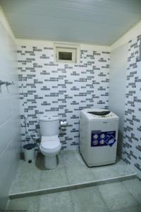a bathroom with a toilet and a water cooler at Apartment lake kurunegala in Kurunegala