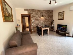 een woonkamer met een bank en een tafel bij DISCOVERY FLAT with pool & bikes in Sirmione