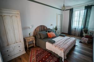 1 dormitorio con 1 cama y suelo de madera en Bed & Breakfast Barbera e Tulipani, en Scandeluzza