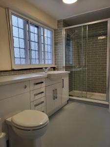 a bathroom with a toilet and a glass shower at York Minster View in York
