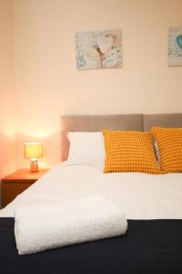 um quarto com uma cama branca e 2 almofadas em Inviting 2-Bed apartment - Perfect for Contractors and Business Travellers em Retford