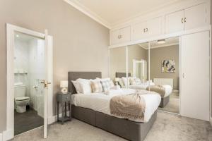 a bedroom with two beds and a bathroom at South Beach View in Troon