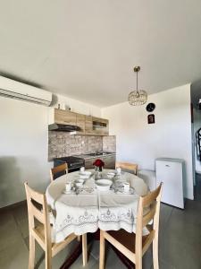 a dining room with a table with chairs and a kitchen at Felix Villa in Nea Plagia