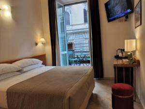 a bedroom with a large bed and a large window at Hotel Principe Eugenio in Rome