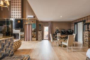 a living room with a table and a dining room at Penthouse Suite Rome - Private Suites in Rome