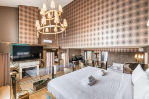 a bedroom with a large bed and a chandelier at Penthouse Suite Rome - Private Suites in Rome +87 photos