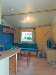 a living room with a blue couch and a table at Villa Ardilla (La Adrada) in La Adrada