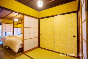 a bedroom with a bed and a sliding glass door at Kyonoyado Gekkoan in Kyoto