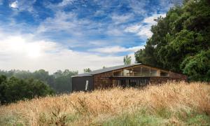 a house on top of a hill in a field at Cabaña en Rio Maullin Nek #1 in Las Quemas del Salto