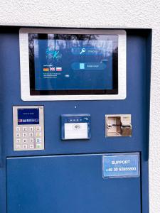 a blue atm machine with a screen on it at Hotel Alex Berlin in Berlin