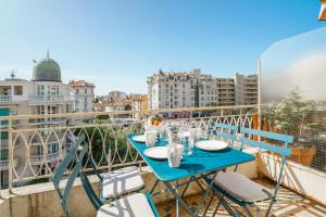 a blue table and chairs on a balcony at Terrasse des Oliviers in Nice