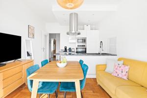 a living room with a table and a couch at Terrasse des Oliviers in Nice