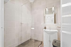 a white bathroom with a sink and a mirror at Terrasse des Oliviers in Nice +11 photos