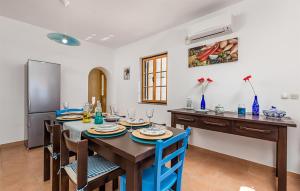 a dining room with a table and chairs and a refrigerator at Amazing Apartment In Jablanac in Jablanac