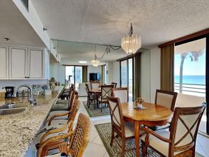 a kitchen and dining room with a table and chairs at Oceans Atrium 205 in Daytona Beach Shores