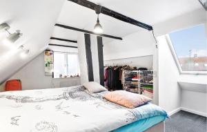a bedroom with a bed in a attic at 1 Bedroom Cozy Home In Rnne in Rønne