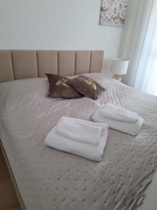 two towels on a bed with two pillows on it at DIAMOND - Luxusný Apartmán Marco in Podhájska