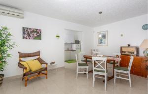 a kitchen and dining room with a table and chairs at 3 Bedroom Pet Friendly Home In Omisalj in Omišalj