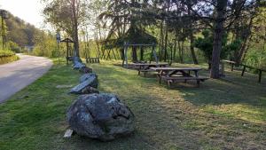 a group of picnic tables and rocks in a park at Casa Nonna Rosa in Ponte in Valtellina