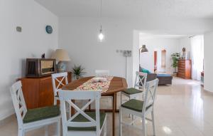 a dining room with a table and chairs at 3 Bedroom Pet Friendly Home In Omisalj in Omišalj