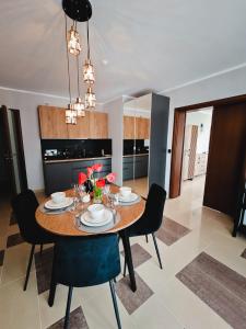 a dining room with a table and chairs at Ava Relax Apartments in Świnoujście