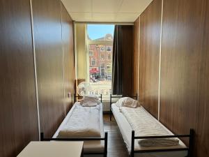 a hospital room with two beds and a window at Hostel Utopia in Amsterdam