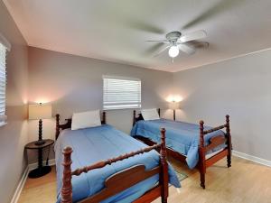 2 Betten in einem Schlafzimmer mit Deckenventilator in der Unterkunft Country Charmer in Sevierville