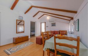 a living room with a table and a dining room at Nice Apartment In Potocnica With House Sea View in Borovići