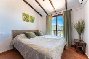 a bedroom with a bed and a large window at CT 269 GR - Faro's Sun, Beach & More in Almuñecar in Almuñécar