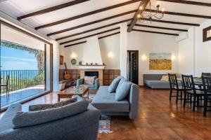 a living room with couches and a living room with a view at CT 269 GR - Faro's Sun, Beach & More in Almuñecar in Almuñécar