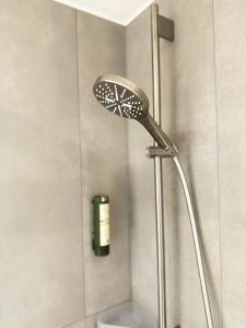 a shower with a shower head in a bathroom at Hotel Elefant in Salzburg