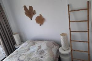a bedroom with a bed and two lights on the wall at Camporrosso Pool View Apartment in Finestrat +15 photos