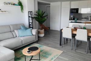 a living room with a couch and a table at Camporrosso Pool View Apartment in Finestrat