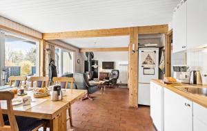 a kitchen and living room with a table and chairs at 3 Bedroom Stunning Home In Rudkbing in Spodsbjerg
