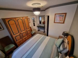 a bedroom with a large bed and a chair at The Sup Shack Wellington Inn in New Quay