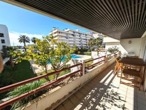 un balcón con mesa y sillas y un edificio en Vilamoura House en Vilamoura