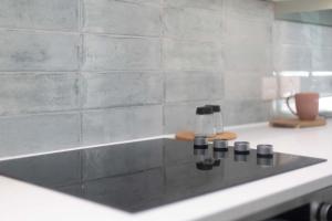 a bathroom counter with a sink with three black knobs at Verulum Apartments - FREE PARKING INCLUDED - 9 mins walk to the beach - Beautifully Designed Luxury Town Centre Apartments by Coastline Retreats in Bournemouth +46 photos