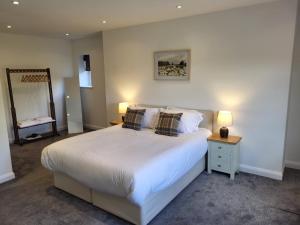 a bedroom with a large white bed with two pillows at Hampstall Inn in Stourport