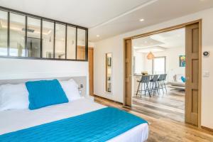 a bedroom with a king sized bed and a living room at Akwabay - Les Villas du Cap in Le Lavandou