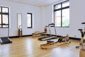 a gym with treadmills and exercise equipment in a room at New Hotel of Marseille - Vieux Port in Marseille